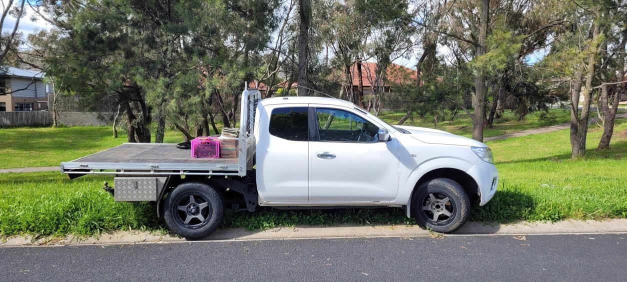 White Nissan ute side view