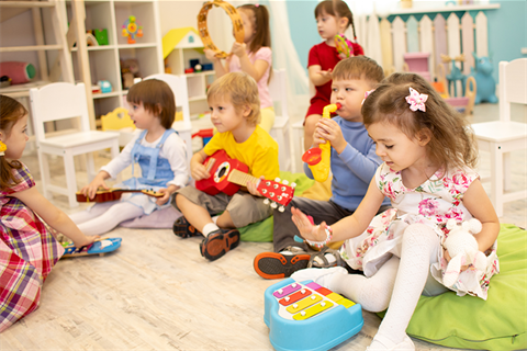 Young children playing with instruments