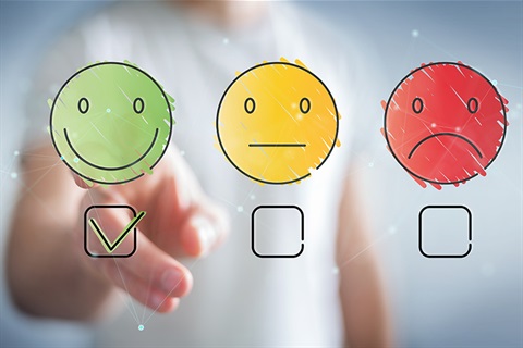 Image showing person selecting happy face graphic to indicate satisfaction