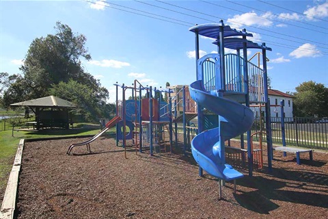 Image of Marj Christian Park showing playground equipment and seating
