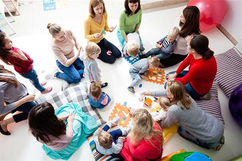 Group of young mums with their babies and toddlers