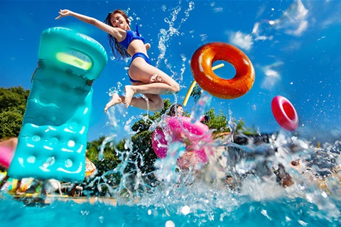 Girls jumping into pool