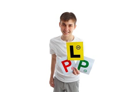 Young male youth holding l an p plates