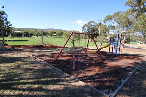 Don R Campbell park showing swings, slide and climbing equipment