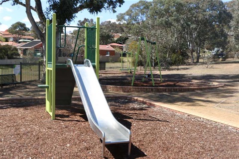 Esmond Avenue Park showing swings, slide and seating