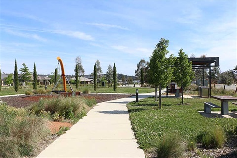 Playground with BBQ and cover seating at John Caragh Park