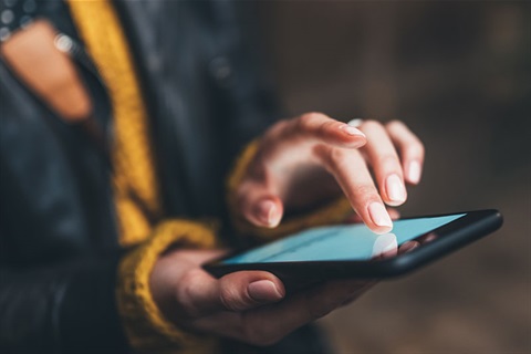 Woman using mobile phone and typing