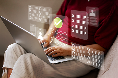 Person completed online forms on a laptop