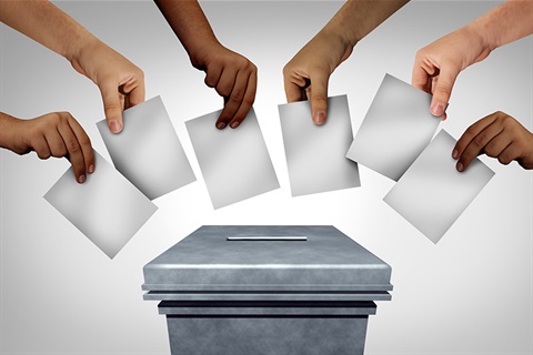 Hands placing vote in box