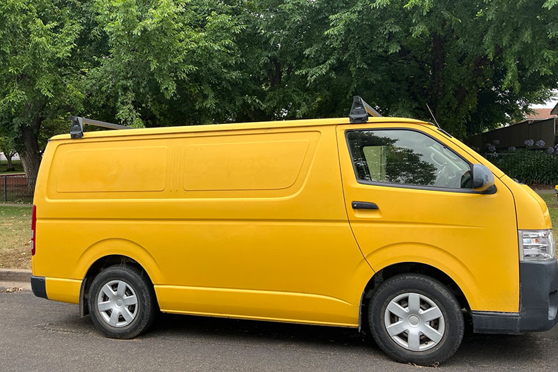 Yellow Toyota Hiace - side on view