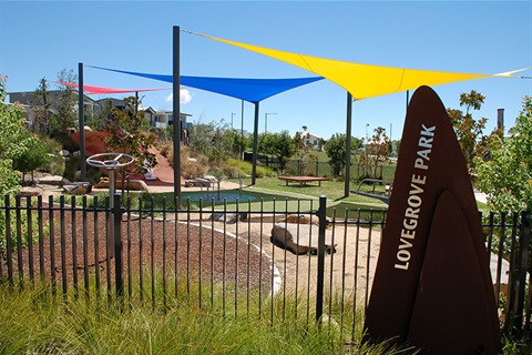 Lovegrove Park showing climbing structure, slippery dip and entrance sign